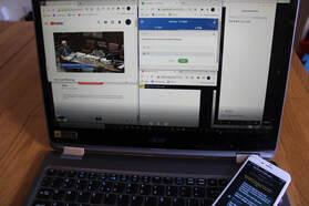 Picture of a laptop and phone with an experience prototype set up.